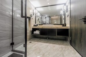 A modern bathroom with a glass shower enclosure, a marble vanity, and a large mirror. - Dihao International Hotel (Guang'an)