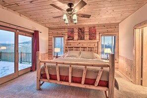 A wooden-paneled bedroom with a bed, large windows, and a ceiling fan. - Spacious Slaty Fork Home ~ 12 Mi to Snowshoe (Slaty Fork)