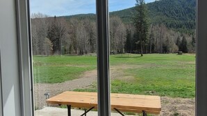 A window with a view of a picnic table outside.