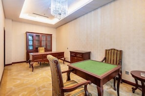 Una habitación con mesa de billar, un armario y una silla.