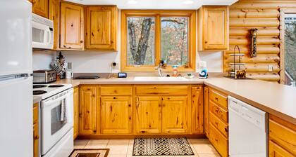 Secluded, dog-friendly home with tree-lined view, firepit, fireplace, & deck