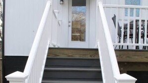 A staircase leading to a white building with a door and windows. - Mall St · Cozy Haven In The City W/Deck <5 min to DT Knox (Knoxville)