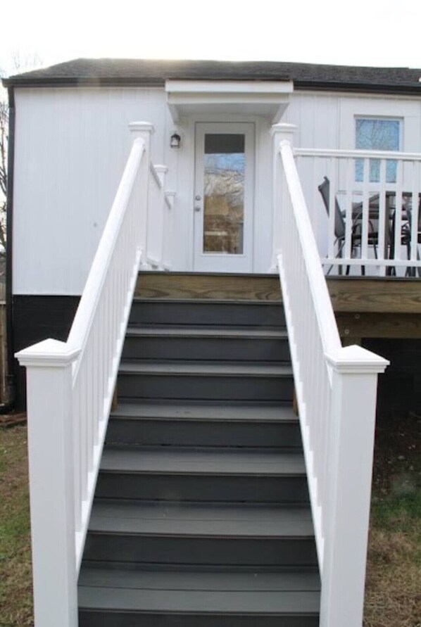 Stunning residential building with a grand staircase and deck area.