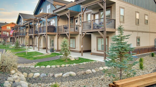 A multi-story hotel with balconies, a landscaped garden, and a wooden deck. - Lovely McCall Retreat < 2 Mi to Payette Lake! (McCall)