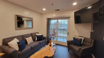 Signature Suite, 1 King Bed with Sofa bed, Jetted Tub, City View | Living room | 65-inch Smart TV with satellite channels, TV, fireplace