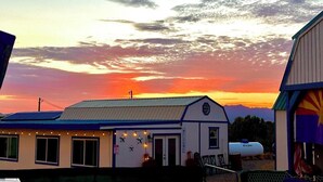 A small building with a blue roof and white walls, featuring a sign that reads "The Ranch." - The Eagle's Nest: Experience Arizona Agritourism (Kingman)
