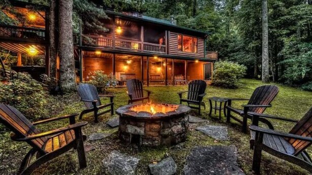 A lodge with a fire pit and outdoor seating. - Directly on Big Creek/Hot Tub/Game Room/Outdoor Living Space/ Remote/True Cabin (Cherry Log)
