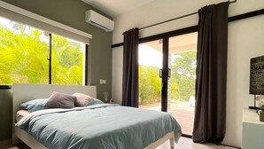A bedroom with a bed, a desk, a ceiling fan, and a view of greenery outside. - splendid villa with its infinity pool offering you a view of nature (Las Terrenas)