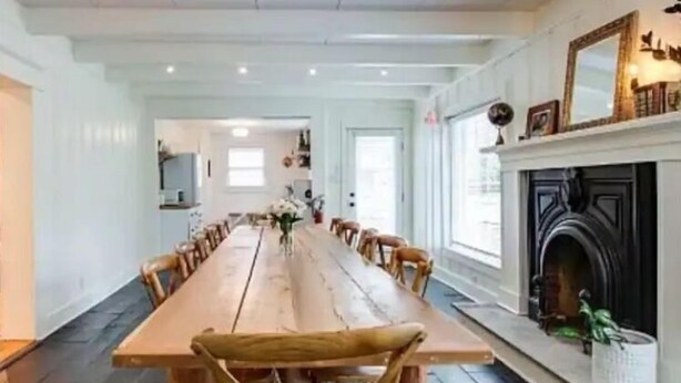 A long dining table with chairs, a fireplace, and a mirror on the wall. - Magnolia Inn - Columbia's Sweet Southern Charmer! (Columbia)