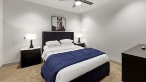 A bedroom with a bed, two bedside tables, a ceiling fan, a wall-mounted picture, and a nightstand. - 175 LEX - Two Bedroom Condo, Walkable Downtown! (Lexington)