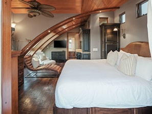 A bedroom with a large bed, a chair, a desk, and a television. - Ocean View Beach Home w/ AC, Outdoor Shower, Walk to PB (San Diego)