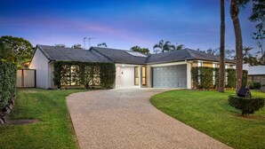 A modern two-story house with a driveway leading to a garage.