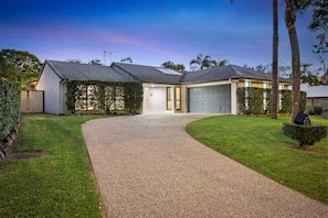 A modern two-story house with a driveway leading to a garage. - 4BR Family Oasis w/ Pool Modern and Spacious (Robina)