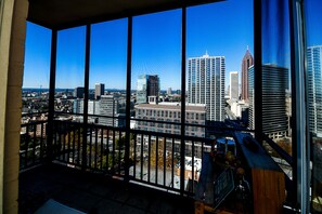 A high-rise building with a view of a cityscape through large windows. - Modern High-Floor condo at Heart of Downtown & Skyline Balcony (Atlanta)