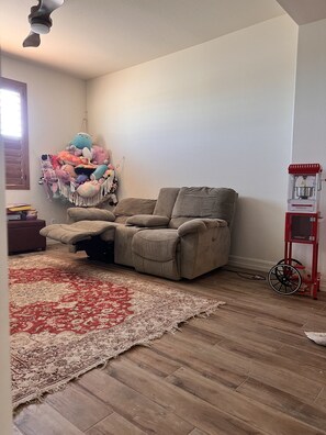 Cozy living room with a plush toy collection and a vintage-style appliance.