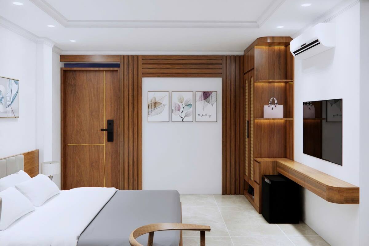 A modern bedroom with a bed, bedside table, and a built-in wardrobe.