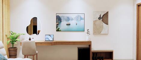 A modern hotel room with a wooden desk, a comfortable sofa, a bed, and a large window.