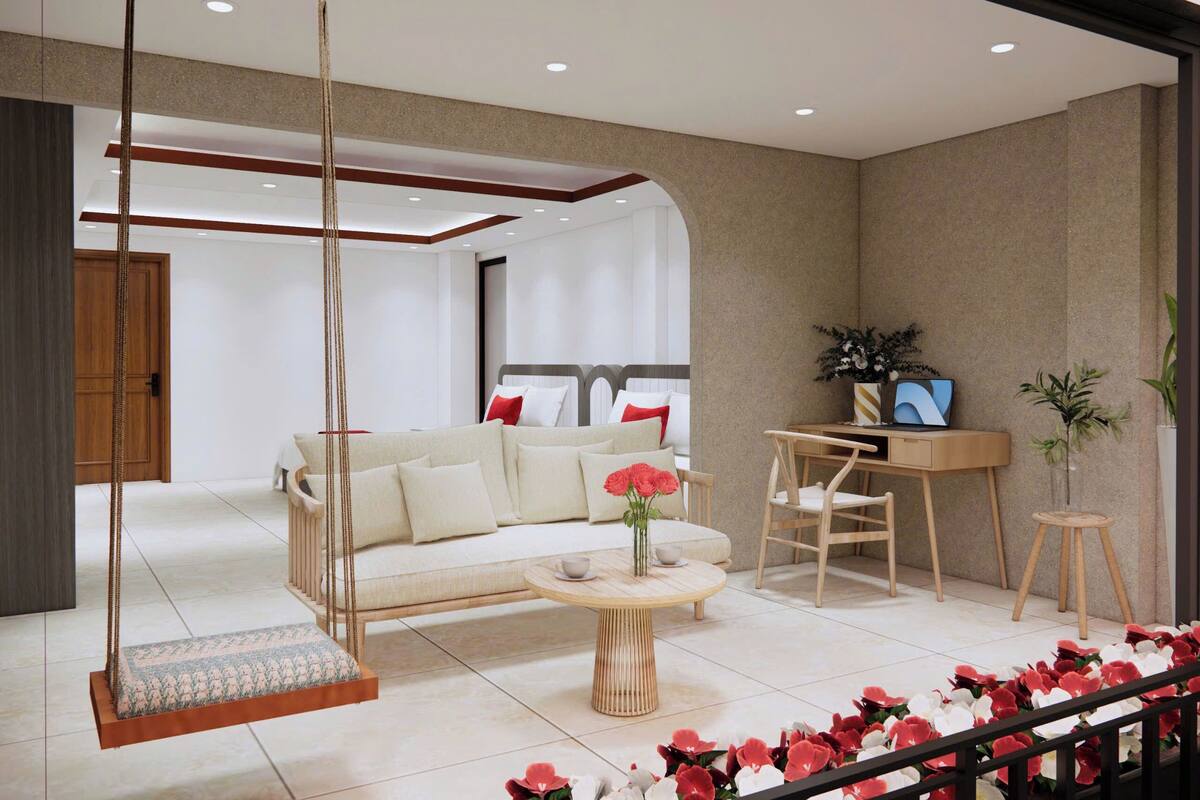 A modern living room with a sofa, a swing chair, a round coffee table, and a desk with a laptop.