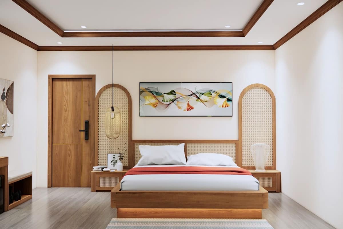 A modern bedroom with a wooden bed, a large abstract painting, and a rattan chair.