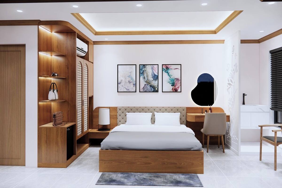 A modern bedroom with a wooden wardrobe, a bed, a desk, and a chair.