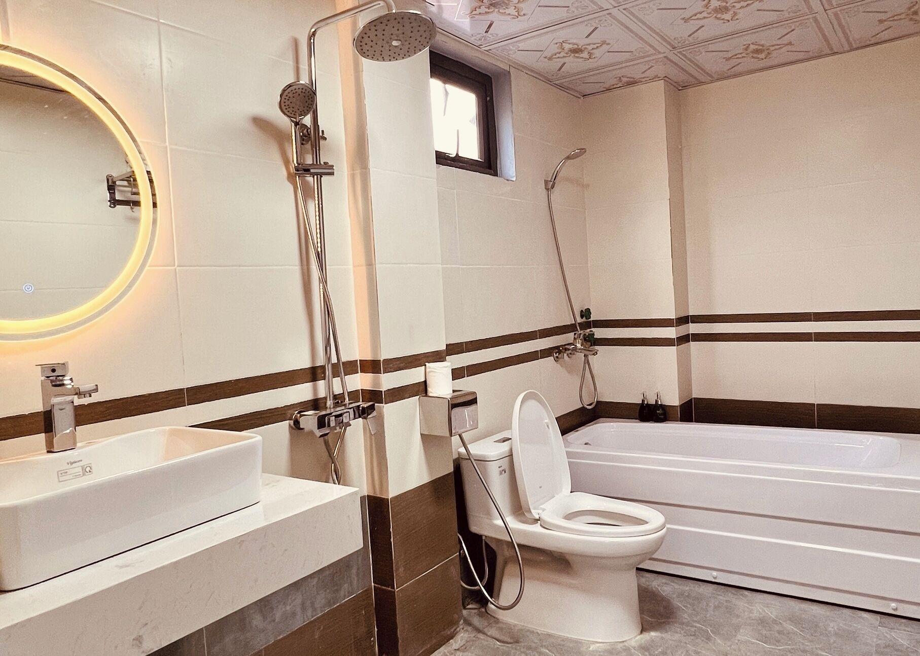 A bathroom with a bathtub, a toilet, and a sink.