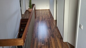 A hallway with wooden flooring, a skylight, a plant, and a door. - Holiday Home 'Anker Perla' with Private Terrace and Wi-Fi (Grömitz)
