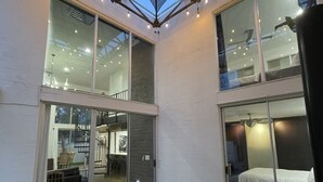 A modern hotel room with a glass ceiling, a small balcony, and a view of the interior. - 3b/2b "Beadle Box" Architectural Loft w/ Doghouse + Golf (Mesa)