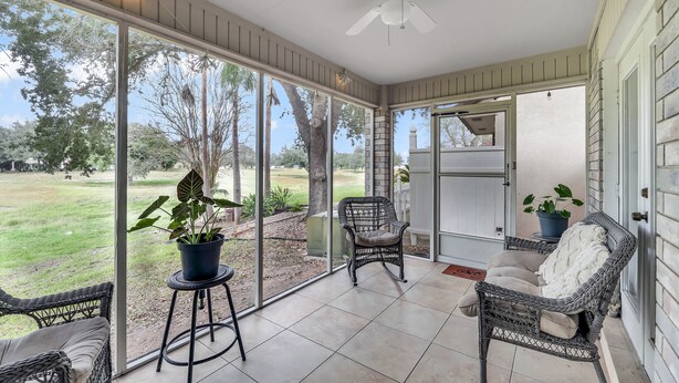 A covered patio with wicker furniture, a ceiling fan, and a view of a grassy area. - The Cozy Houz at Cimarron! With Golf Course View (Mission)