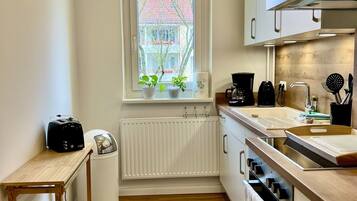 Fridge, stovetop, dishwasher, coffee/tea maker