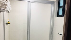 A bathroom with a shower, toilet, and a blue mat on the floor. - Department, Studio Type Excellent Location (Mexico City)