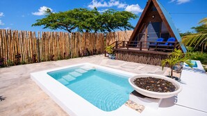 A wooden A-frame structure with a pool and lounge chairs. - Cashaw Cabin - Private Retreat With a Pool (Treasure Beach)