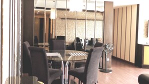 A modern dining area with a glass table, metal chairs, and a fan. - 7A - 2 Bedrooms and 2 Bathrooms Located at Downtown Apartment With Shared Pool (Bangkok)