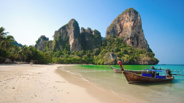 A beach with boats, clear water, and a large rock formation. - B201 - 1 Bedroom Condo With Sea View, Ao Nang Beach (Krabi)