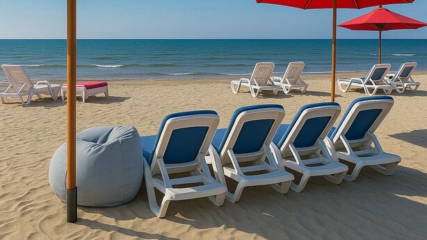 A beach with rows of white lounge chairs and red umbrellas, a wooden post, and a grey bean bag chair. - Modern Design, Mediterranean Vibes Porto Said (Al-Manasrah)