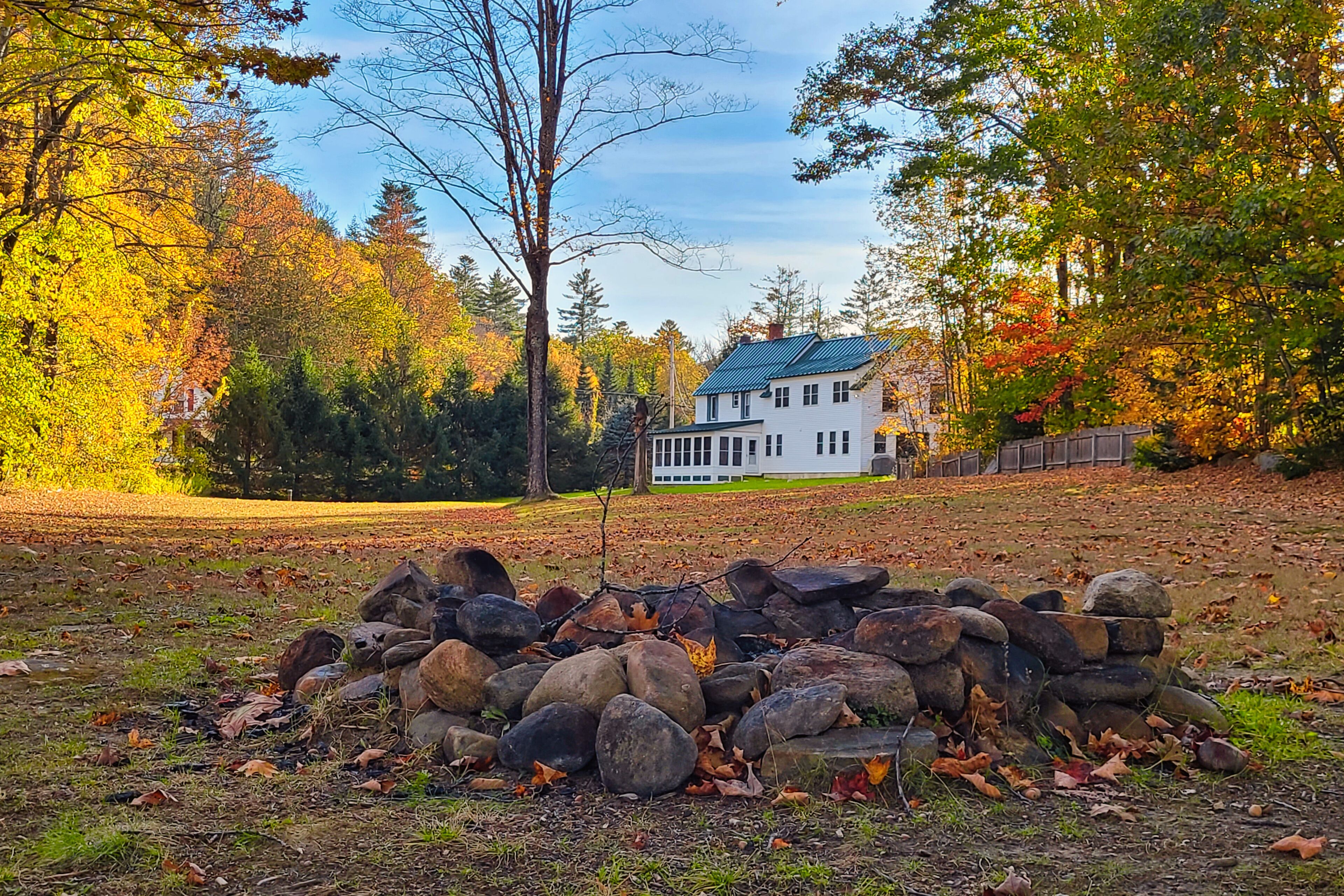 Lakefront home with large yard, firepit, canoe, and fireplace
