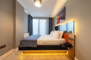 A hotel room with a bed, bedside table, and a telephone. - 216 Bosphorus (Istanbul)