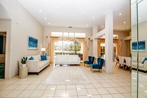 Smart TV, fireplace, books, offices - Luxury Retreat 4 BR Mediterranean Home w/ Heated Pool | Steam Room | Golf Views | Spacious Lanai (Zephyrhills)