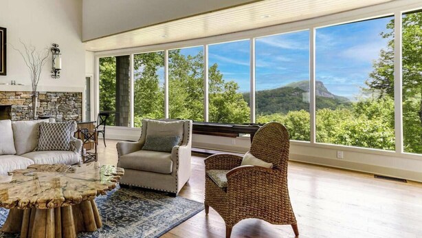 A spacious living room with a large window offering a view of a mountainous landscape. - The View From Up Here Changes Everything | Big Bear Pen (Highlands)