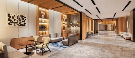 Un moderno vestíbulo de hotel con suelo de mármol, sofás, sillones y una zona de bar.