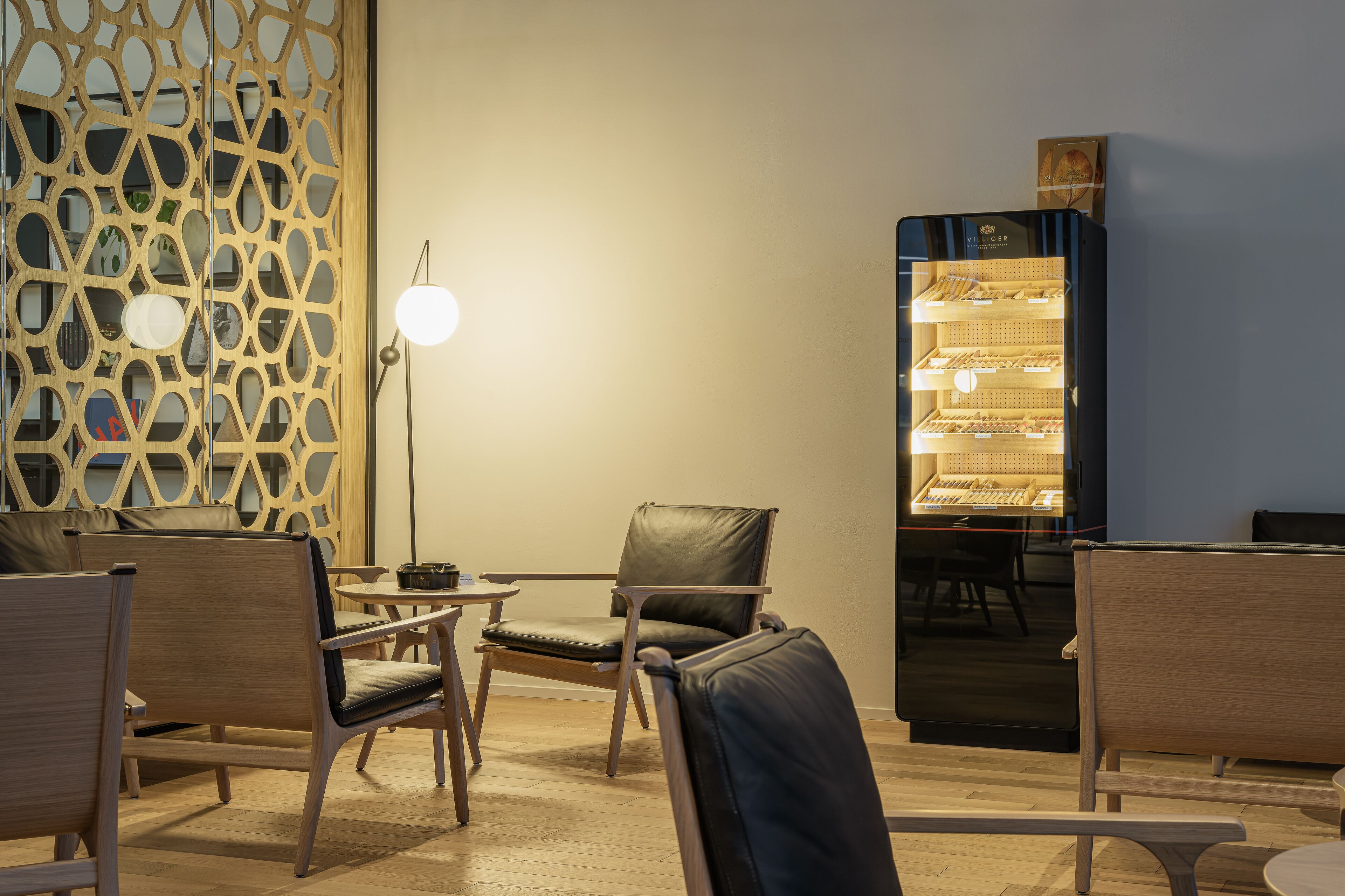 A modern interior with wooden furniture, a decorative partition, and a bakery display.