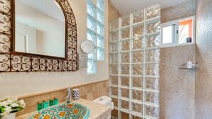 A bathroom with a patterned sink, a toilet, and a shower with frosted glass doors. - 'Villa Tiphareth' with Private Pool, Wi-Fi and Air Conditioning (Marbella)