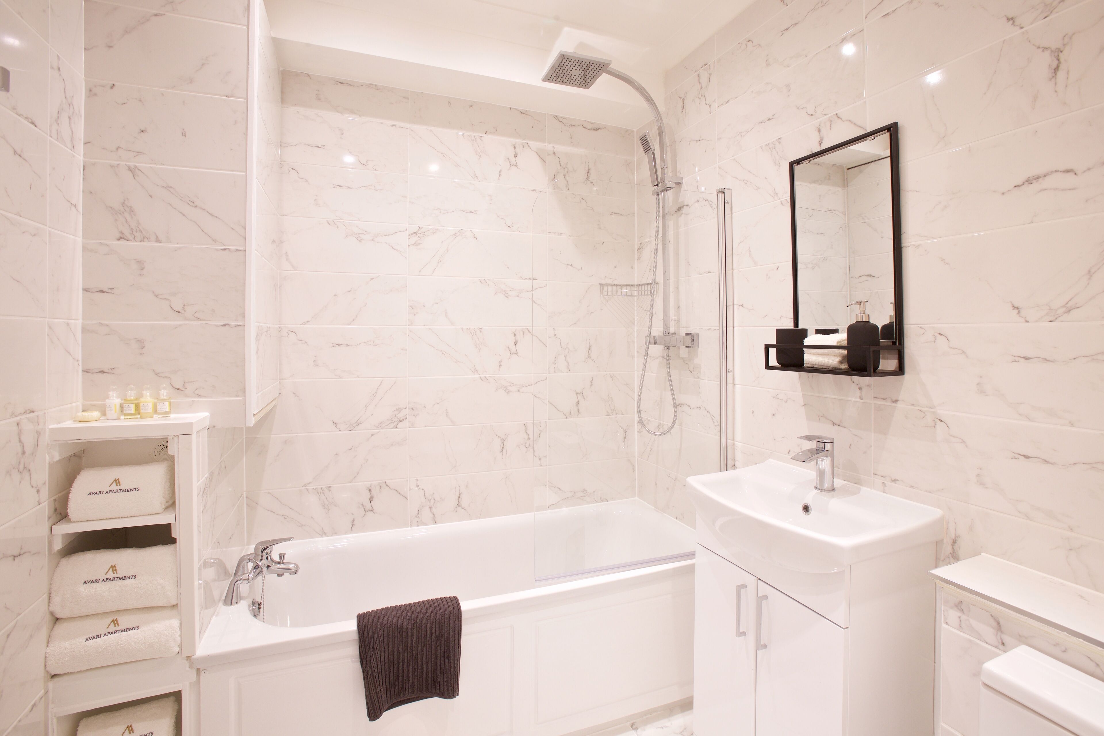 A modern bathroom with a bathtub, a sink, and a shower.