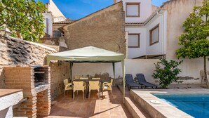 A patio with a grill, outdoor seating, and a pool. - Holiday Home "Adriana" with Private Pool, Terrace, and Wi-Fi (Murchas)
