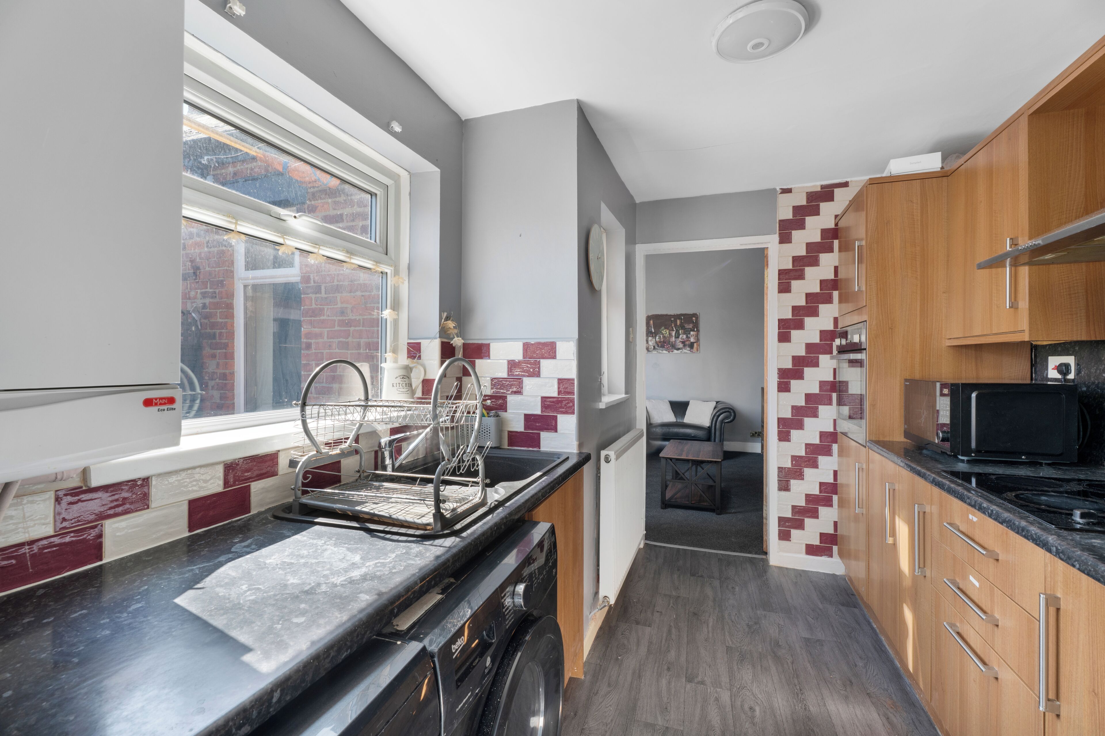 A compact kitchen with a built-in dishwasher, a microwave, and a stove.