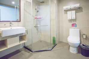 A bathroom with a glass-enclosed shower, a white sink, and a toilet. - Shankee Tea Style Hotel (Mangshi Street) (Mangshi)