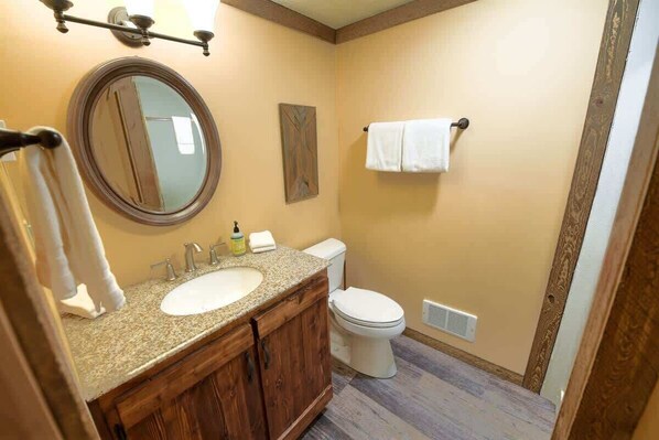 Bathtub, hair dryer, towels, shampoo