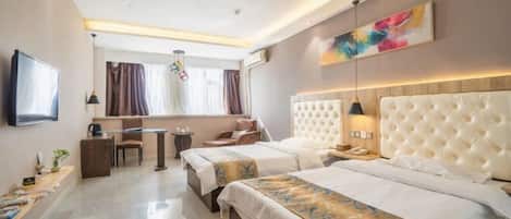 A hotel room with two beds, a desk, a TV, and a large window with curtains.