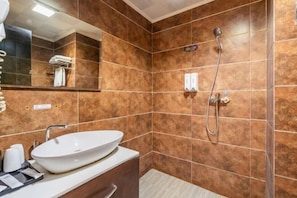 A modern bathroom with a large mirror, a white sink, and a shower. - Loft Hotel (Changyi)