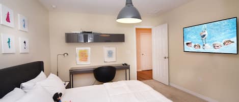 A bedroom with a bed, a desk, a chair, a ceiling light, and a wall-mounted TV.