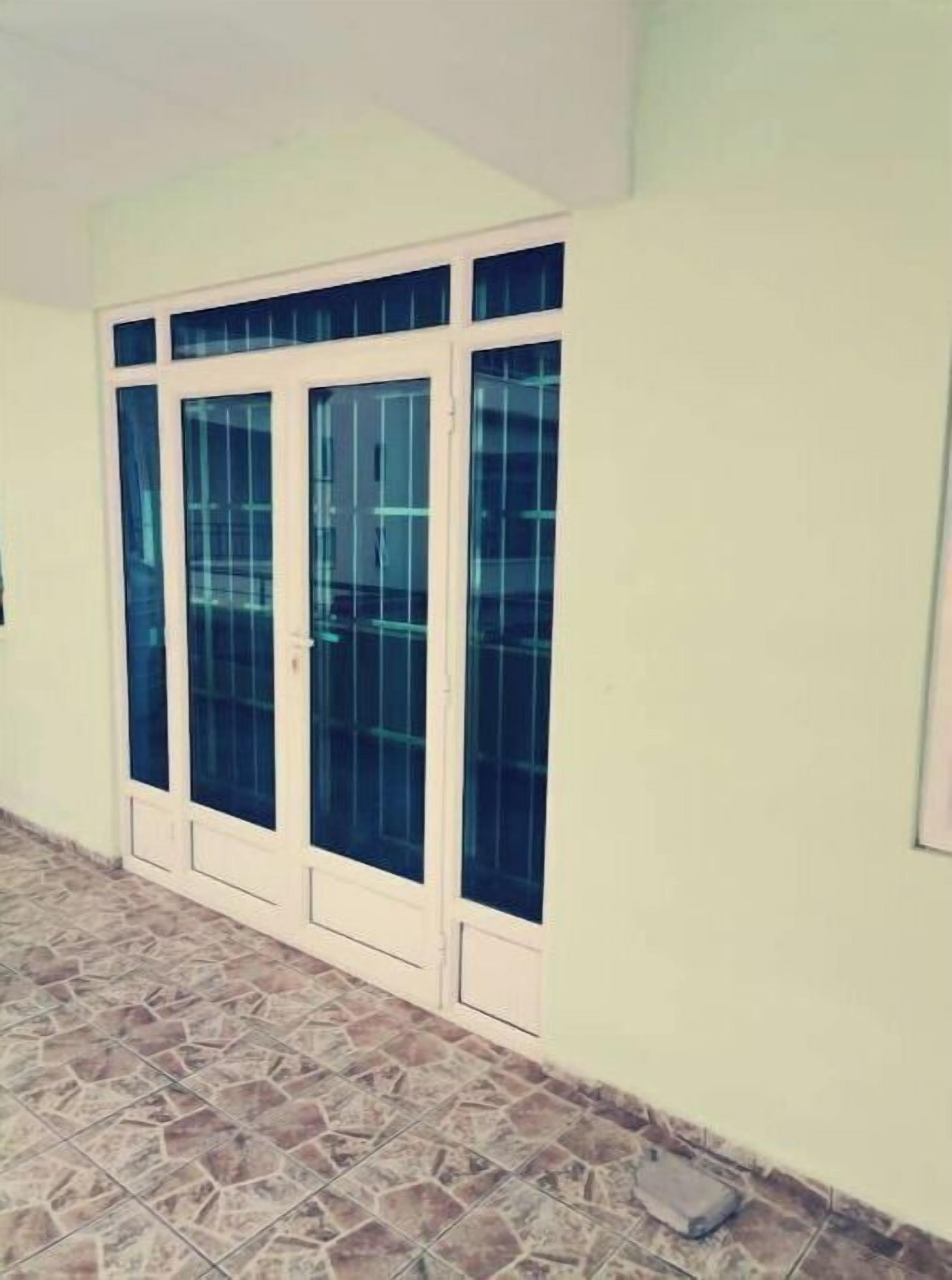 A building with a large glass door and a tiled floor.